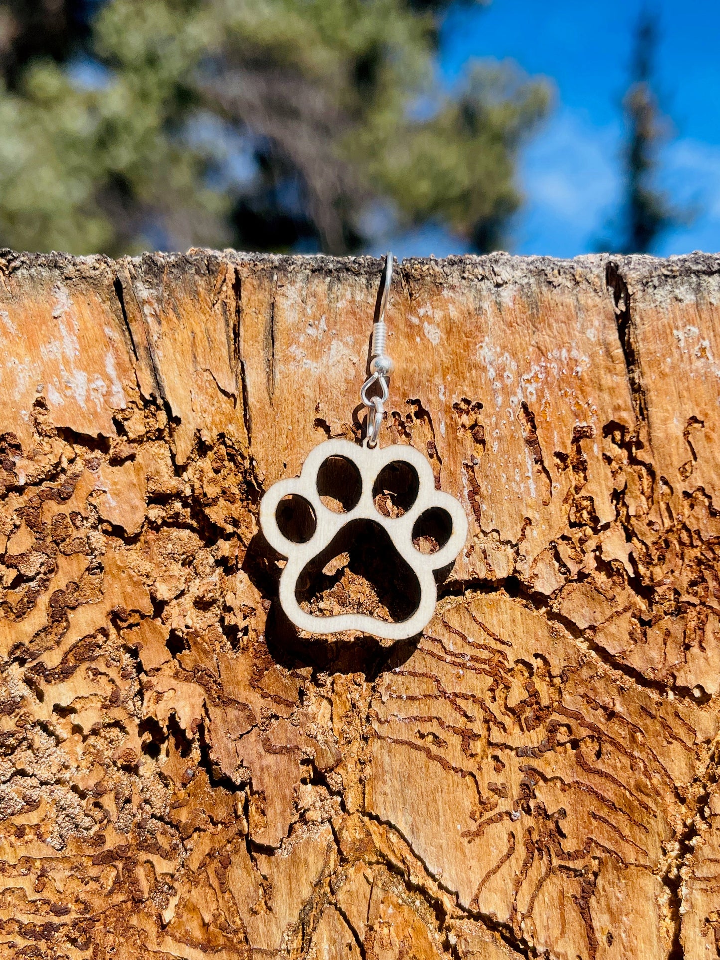Single paw print dangle earrings to show the love for your favorite dog or cat. They are laser cut, lightweight birchwood dangle earring that can be worn easily all day. Great gift for mom or any pet lover.