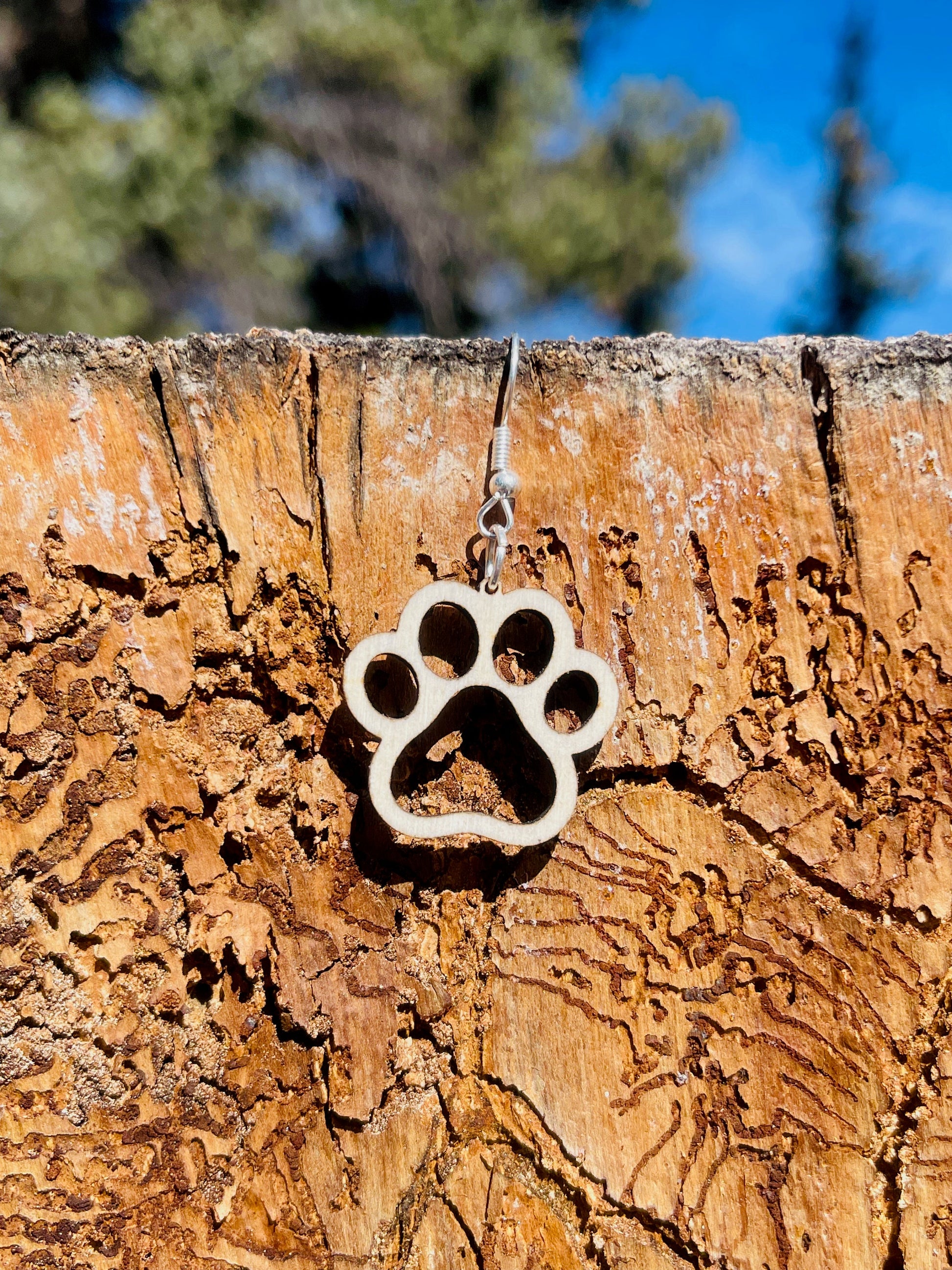 Single paw print dangle earrings to show the love for your favorite dog or cat. They are laser cut, lightweight birchwood dangle earring that can be worn easily all day. Great gift for mom or any pet lover.