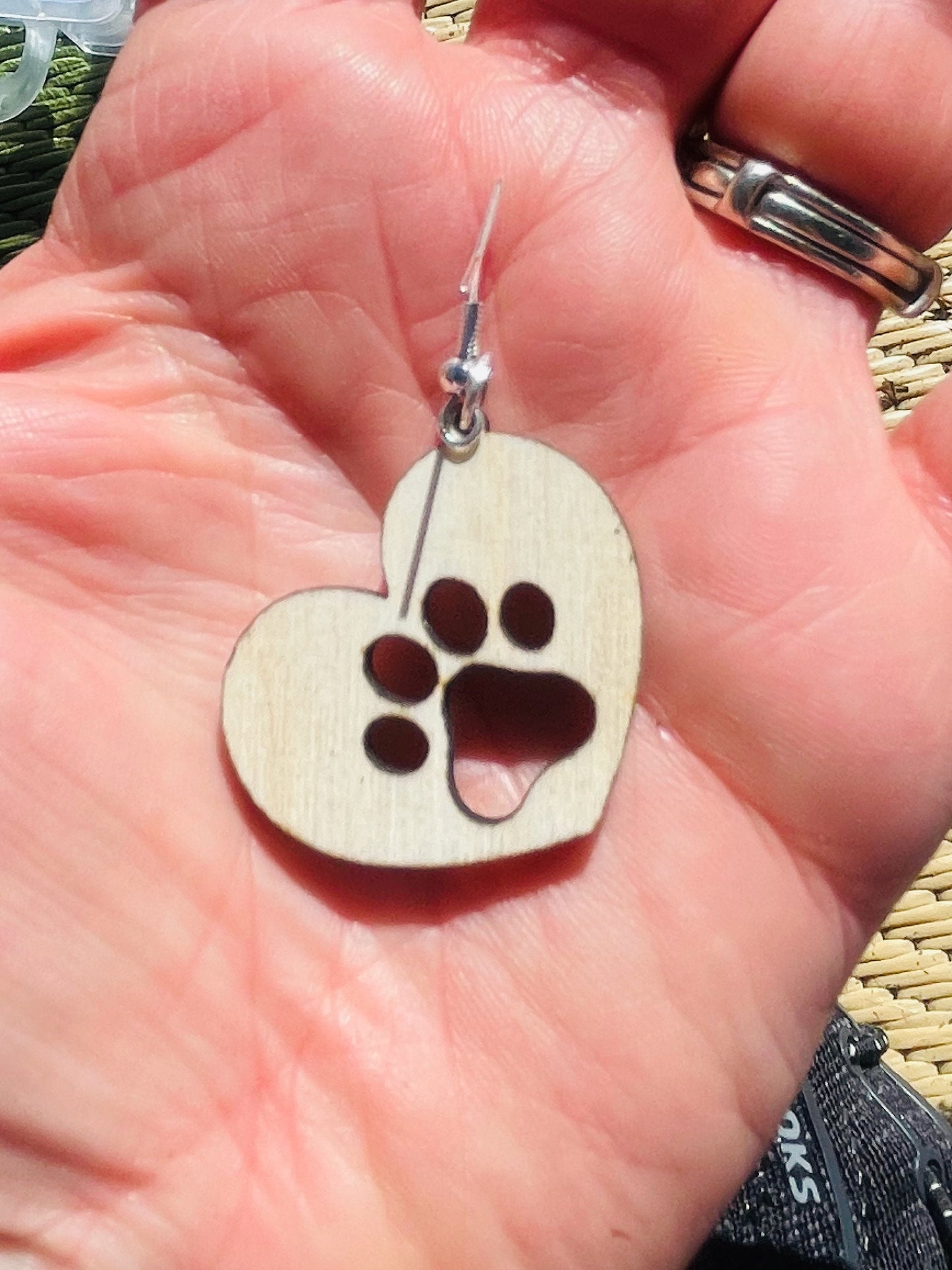 Solid heart dangle earring with a single paw print, hanging from the top side of the heart. They are laser cut, lightweight birchwood dangle earring that can be worn easily all day. Great gift for mom or any pet lover.