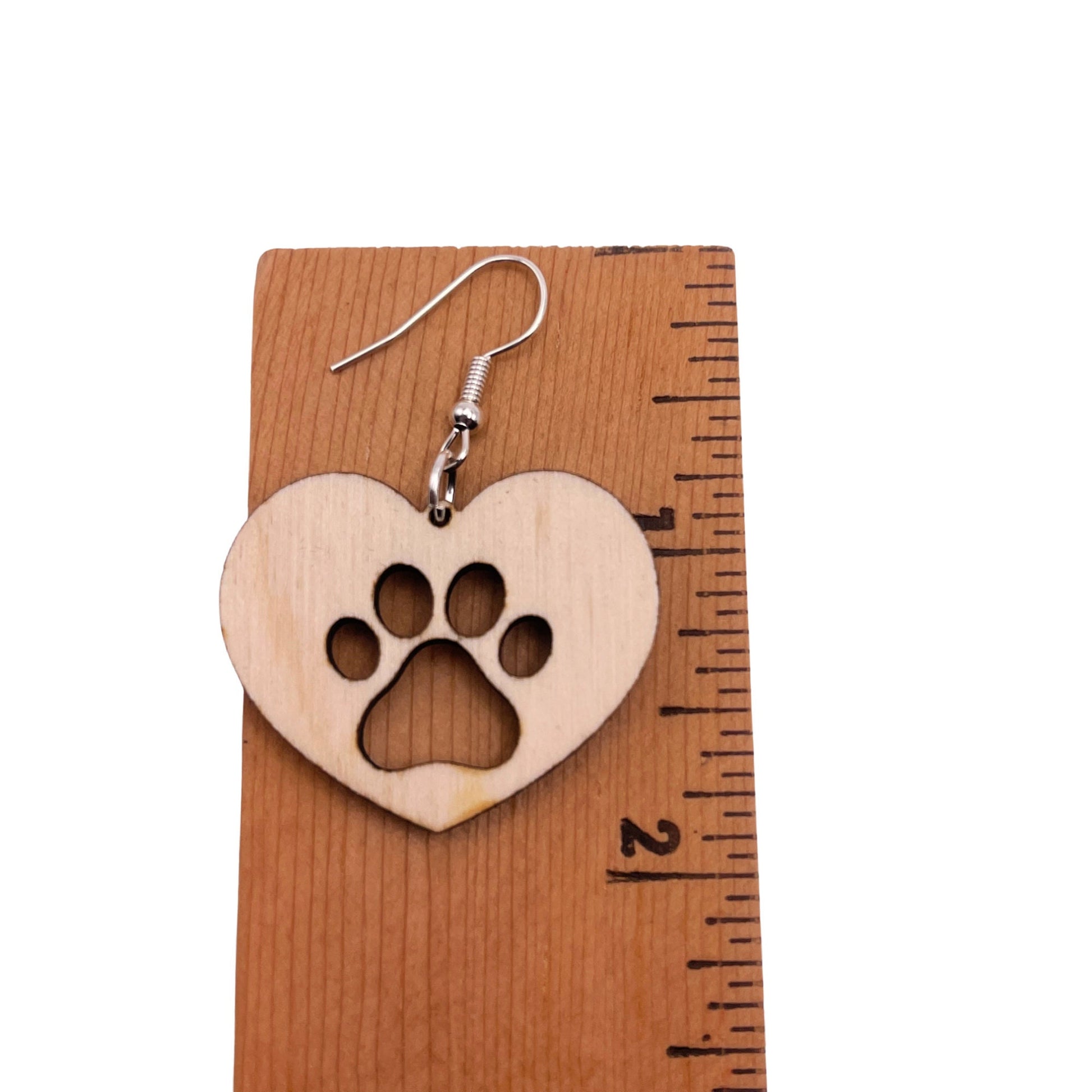 Solid heart dangle earring, approximately 2 inches, with a single paw print to show the love for your favorite dog or cat. They are laser cut, lightweight birchwood dangle earring that can be worn easily all day. Great gift for mom or any pet lover.