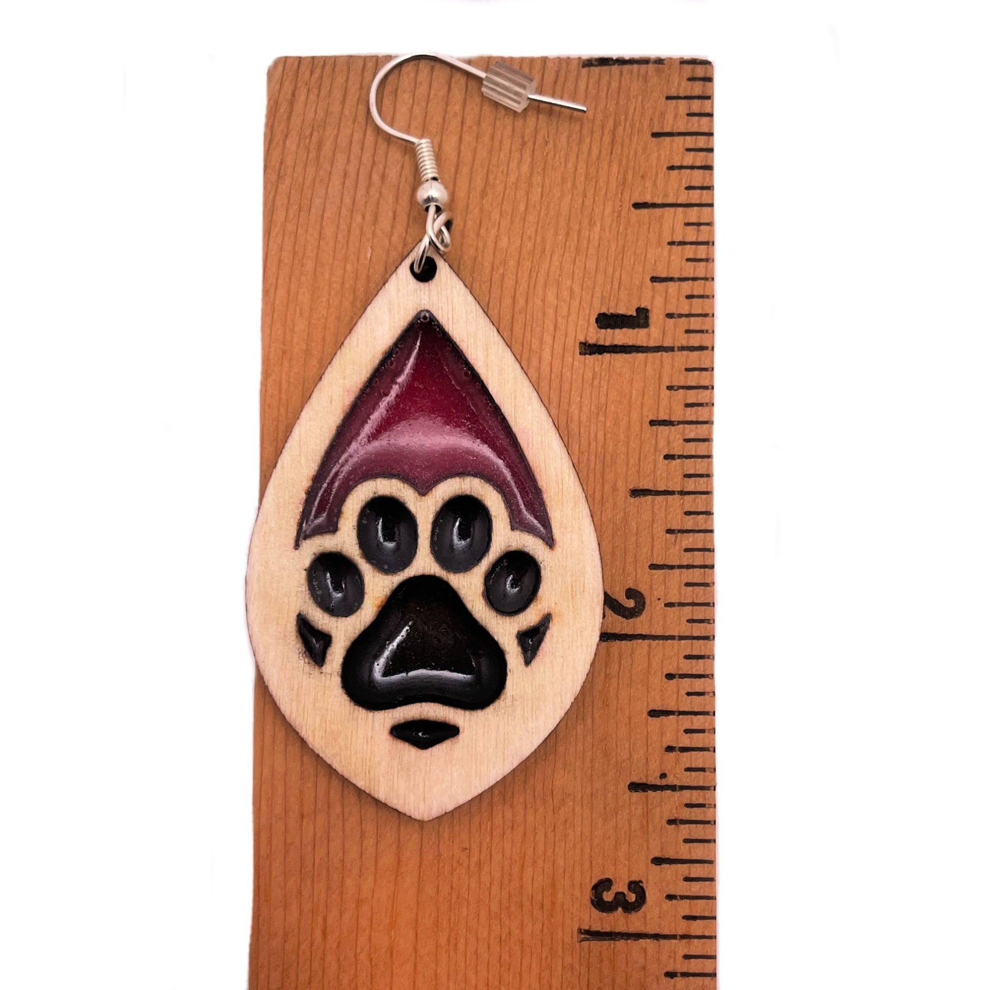Tear drop dangle earring with a single paw print with pink and black resin, approximately 2.5 inches. They are laser cut, lightweight birchwood dangle earring that can be worn easily all day. Great gift for mom or any pet lover.
