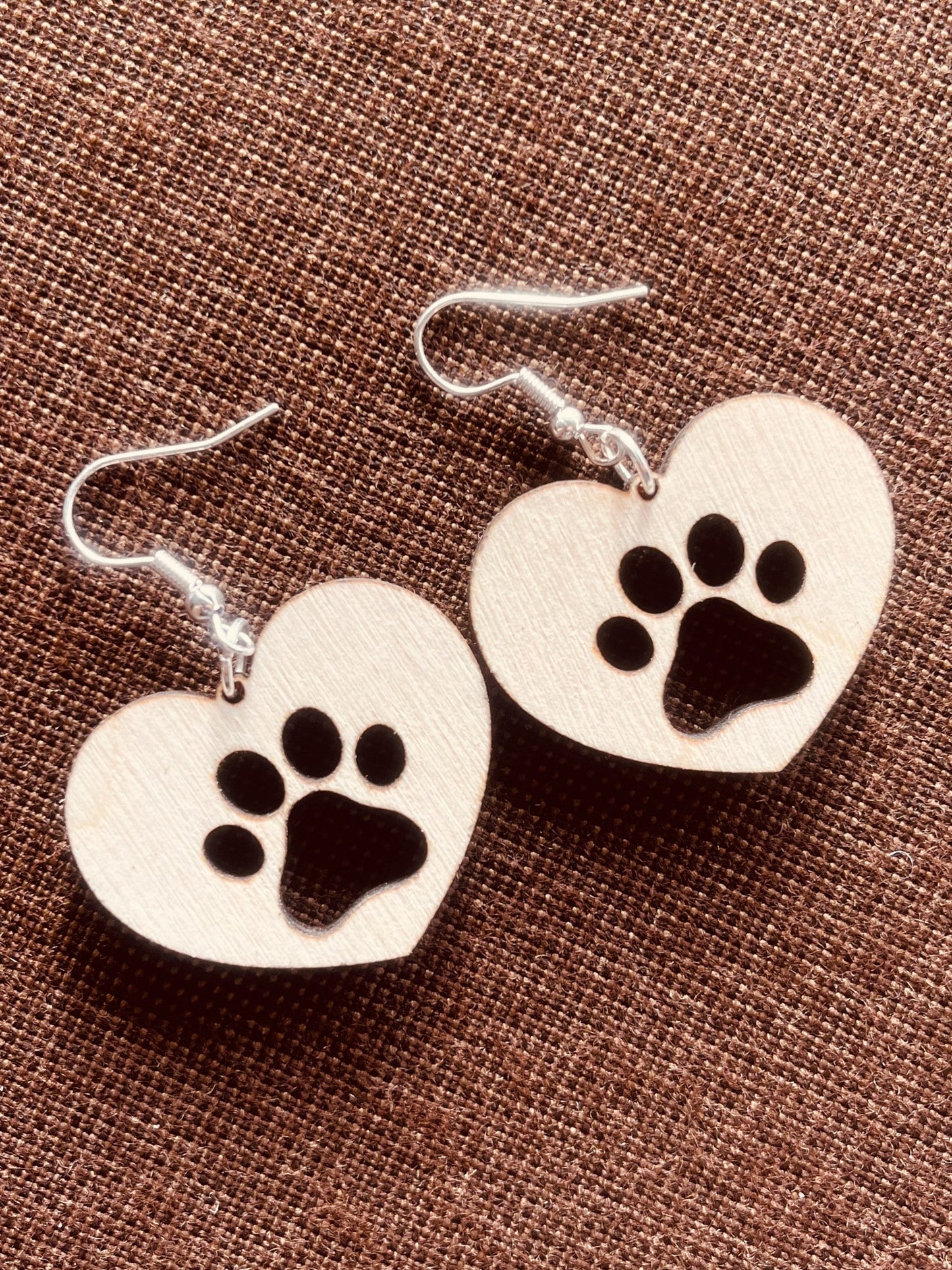 Solid heart dangle earring with a single paw print to show the love for your favorite dog or cat. They are laser cut, lightweight birchwood dangle earring that can be worn easily all day. Great gift for mom or any pet lover.