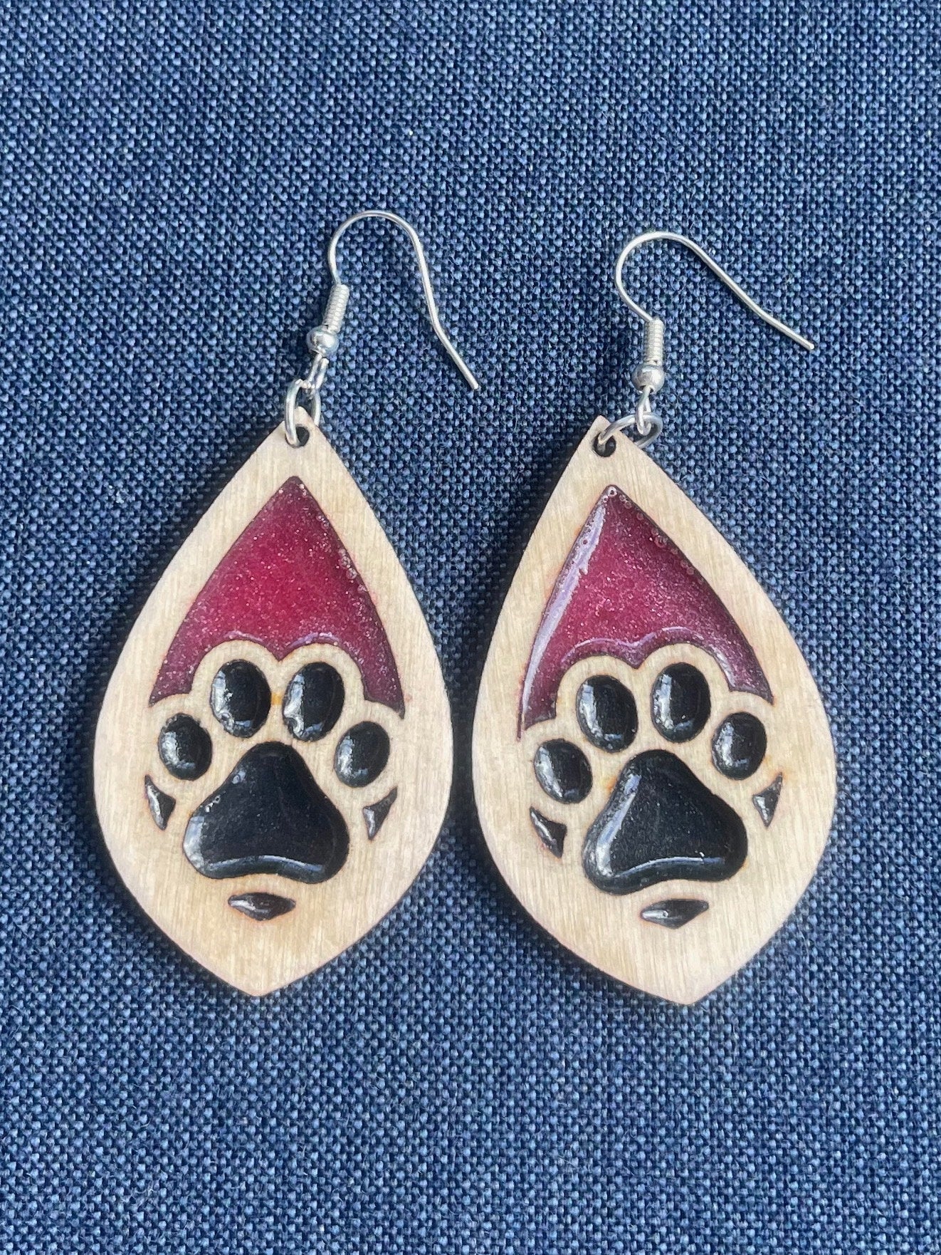 Tear drop dangle earring with a single paw print with pink and black resin.  Show the love for your favorite dog or cat! They are laser cut, lightweight birchwood dangle earring that can be worn easily all day. Great gift for mom or any pet lover.