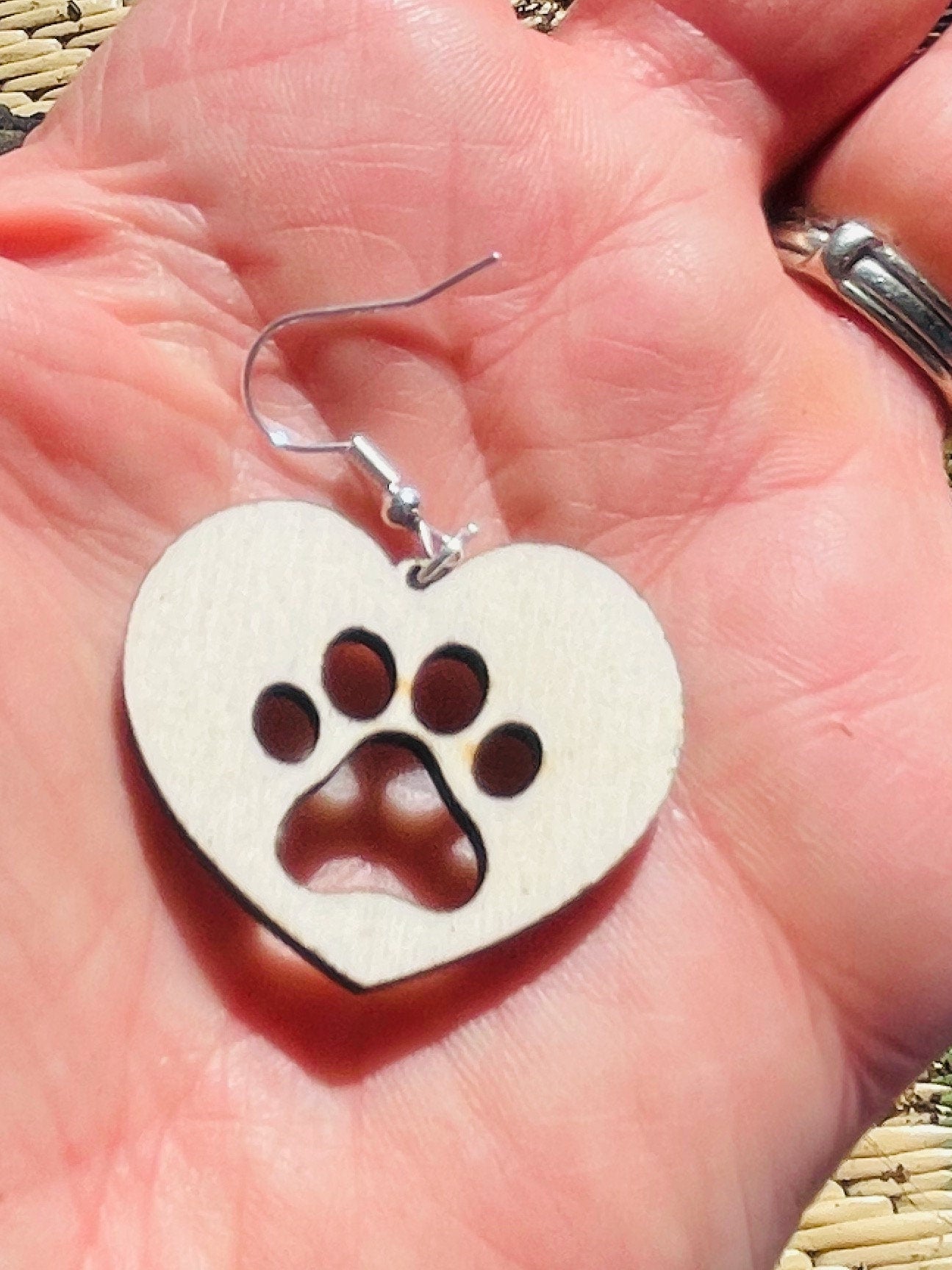 Solid heart dangle earring with a single paw print to show the love for your favorite dog or cat. They are laser cut, lightweight birchwood dangle earring that can be worn easily all day. Great gift for mom or any pet lover.