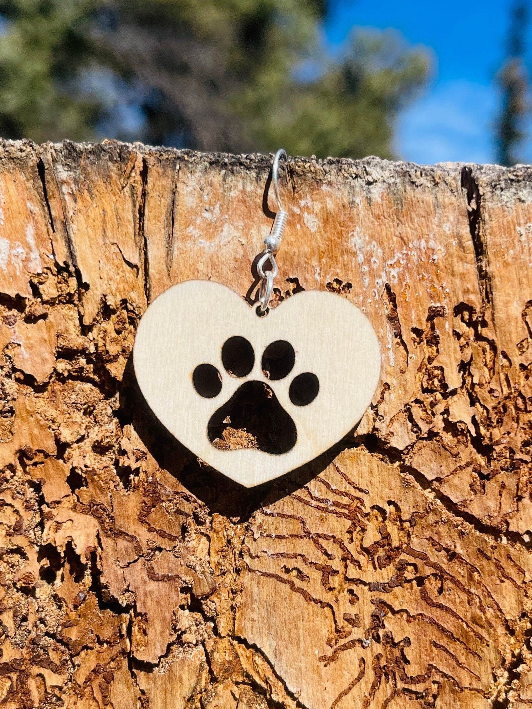 Solid heart dangle earring with a single paw print to show the love for your favorite dog or cat. They are laser cut, lightweight birchwood dangle earring that can be worn easily all day. Great gift for mom or any pet lover.