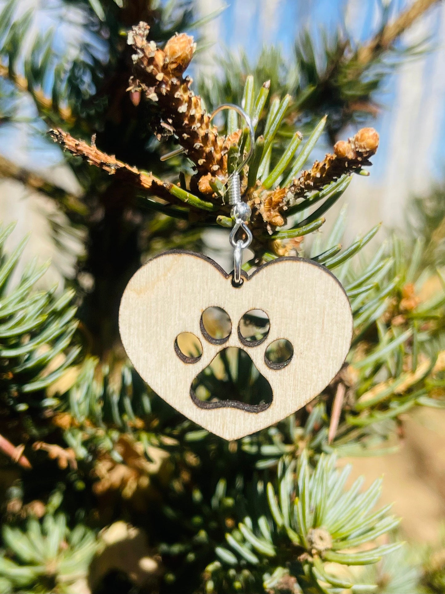 Solid heart dangle earring with a single paw print to show the love for your favorite dog or cat. They are laser cut, lightweight birchwood dangle earring that can be worn easily all day. Great gift for mom or any pet lover.