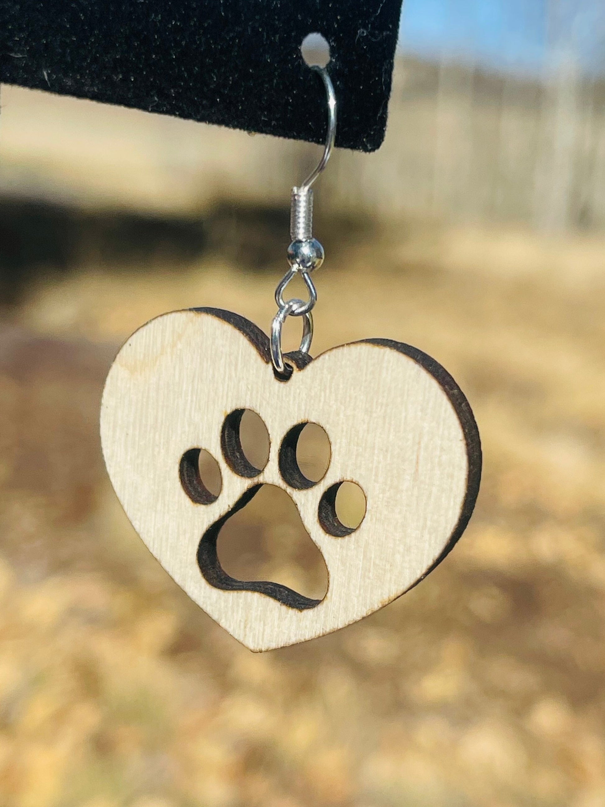 Solid heart dangle earring with a single paw print to show the love for your favorite dog or cat. They are laser cut, lightweight birchwood dangle earring that can be worn easily all day. Great gift for mom or any pet lover.