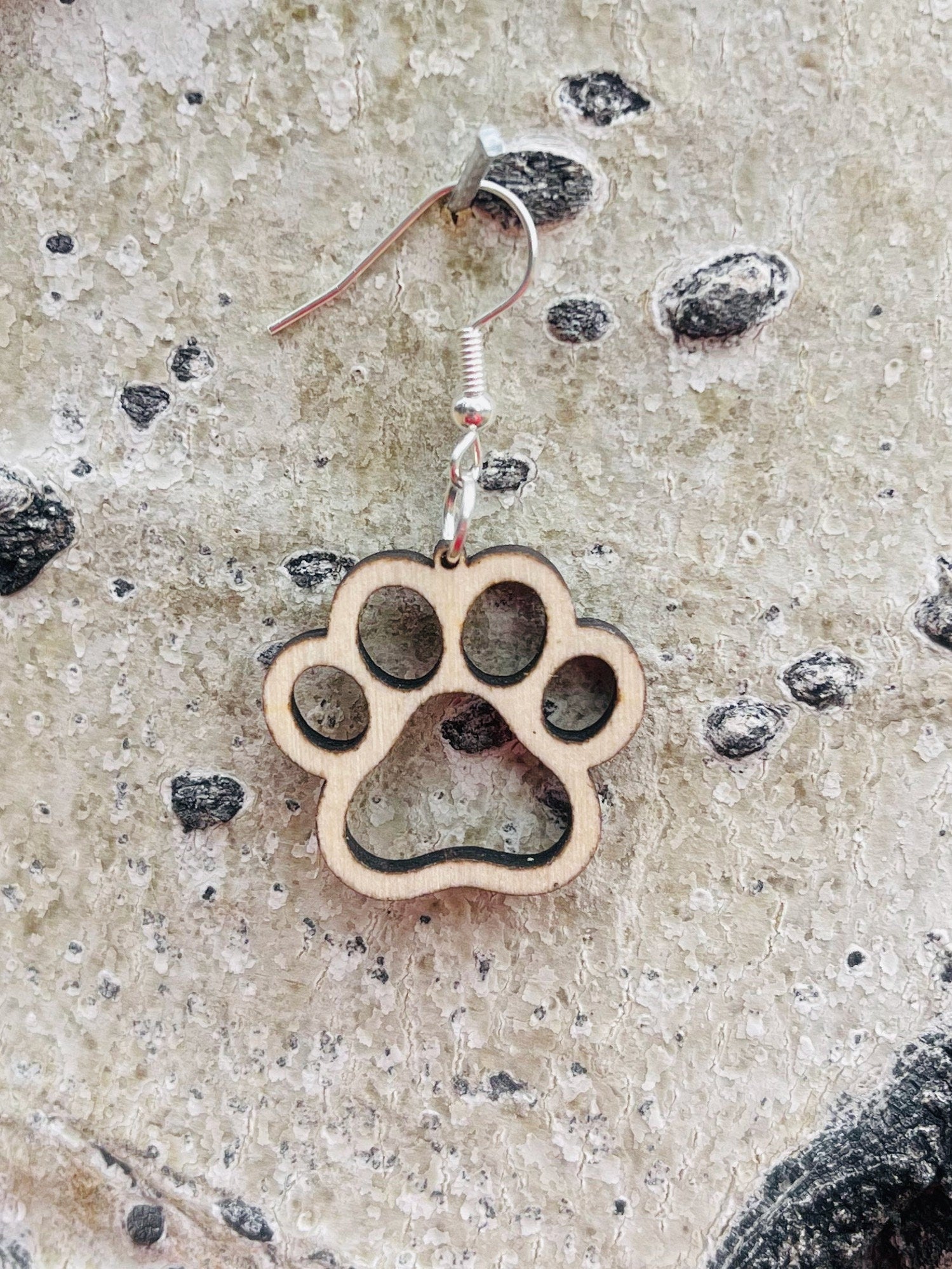 Single paw print dangle earrings to show the love for your favorite dog or cat. They are laser cut, lightweight birchwood dangle earring that can be worn easily all day. Great gift for mom or any pet lover.