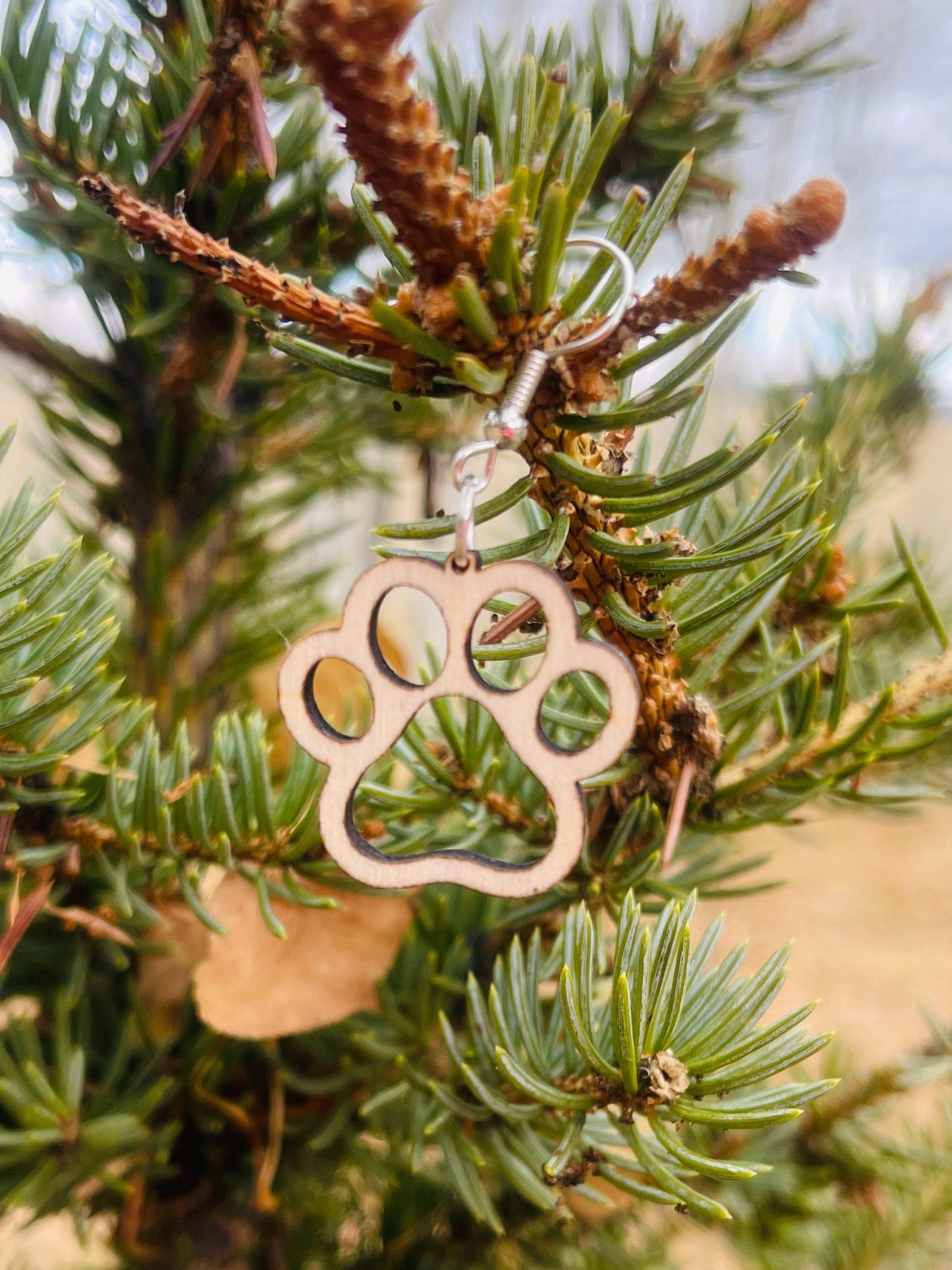 Single paw print dangle earrings to show the love for your favorite dog or cat. They are laser cut, lightweight birchwood dangle earring that can be worn easily all day. Great gift for mom or any pet lover.