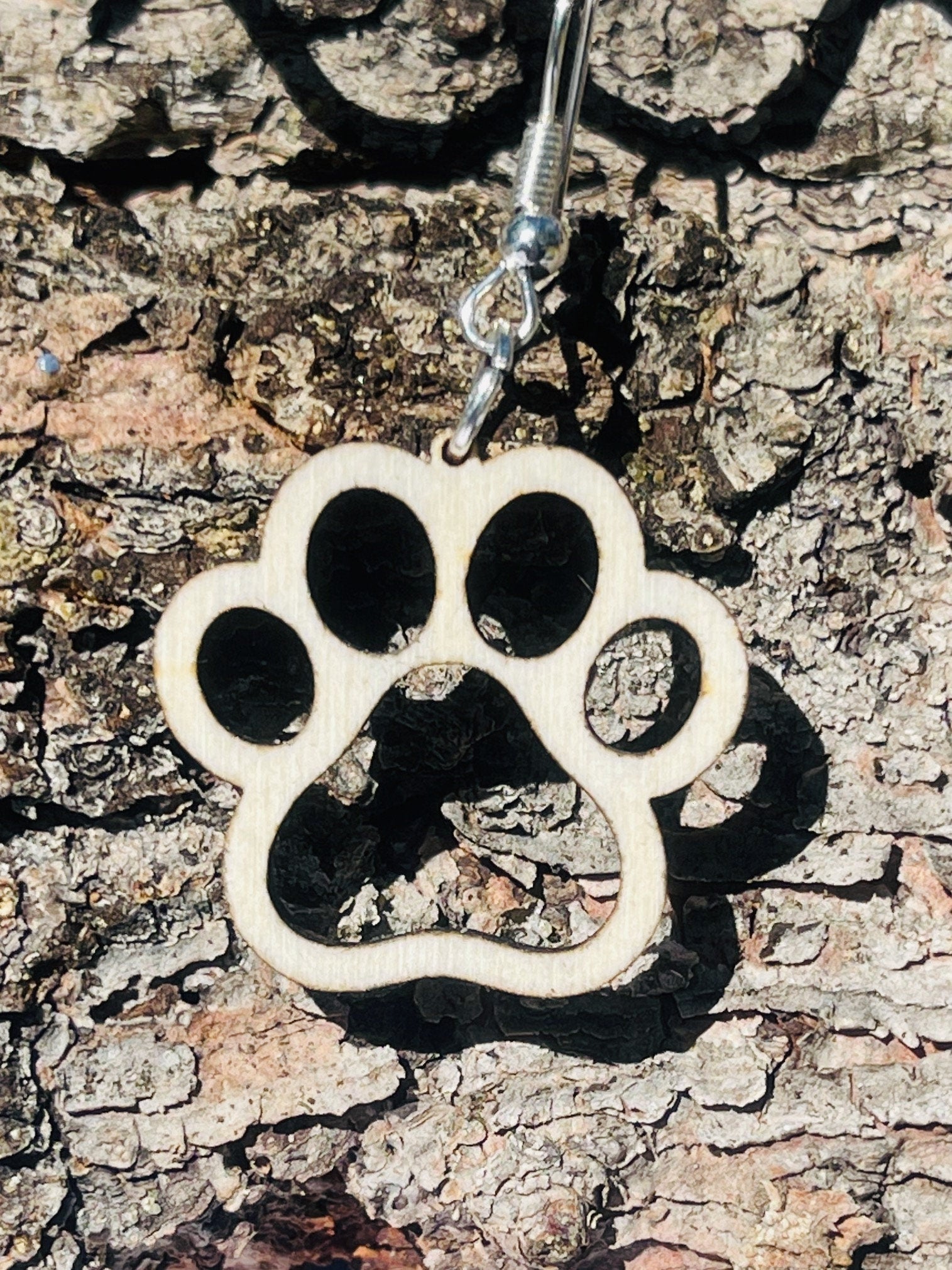 Single paw print dangle earrings to show the love for your favorite dog or cat. They are laser cut, lightweight birchwood dangle earring that can be worn easily all day. Great gift for mom or any pet lover.