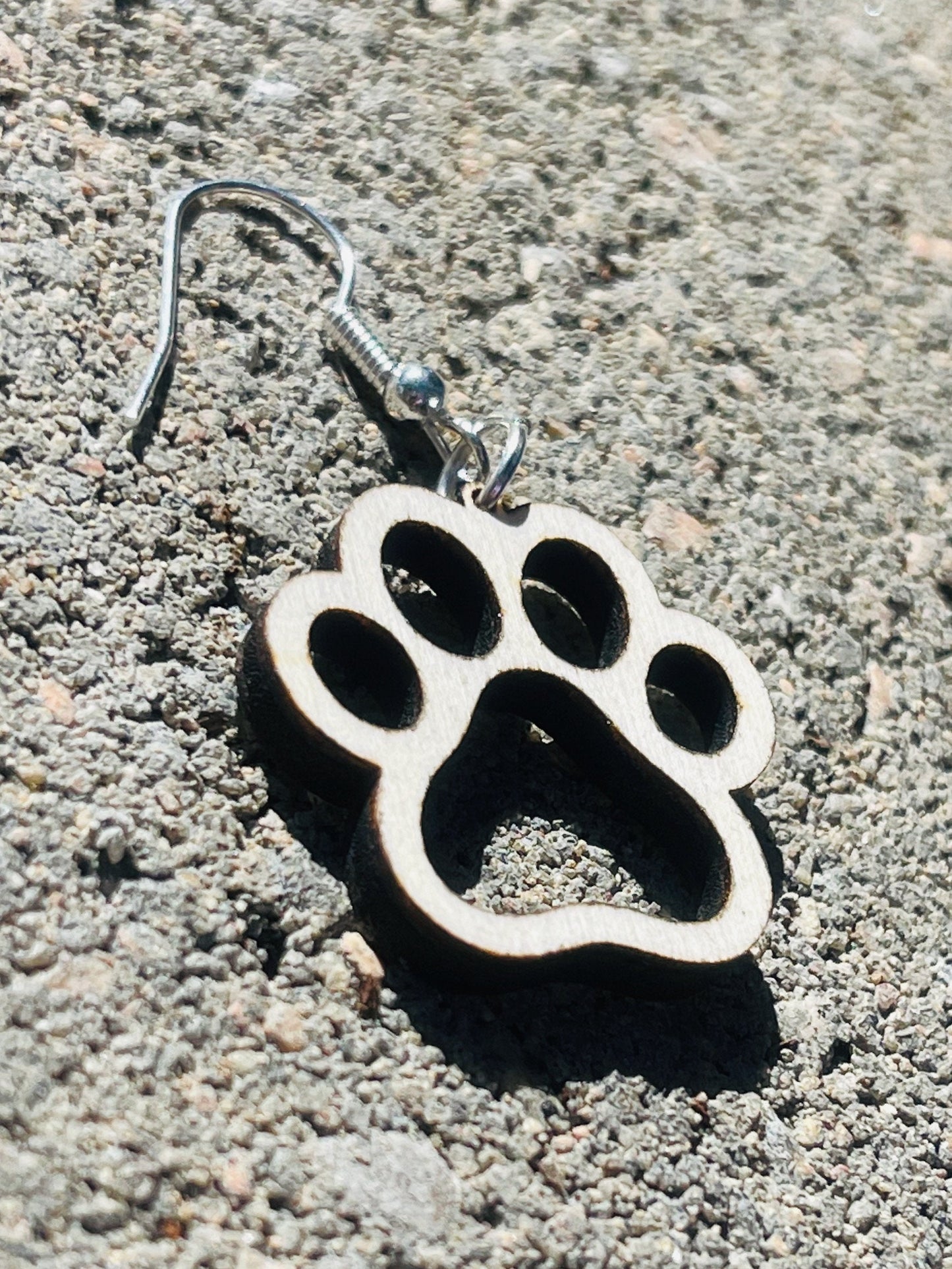 Single paw print dangle earrings to show the love for your favorite dog or cat. They are laser cut, lightweight birchwood dangle earring that can be worn easily all day. Great gift for mom or any pet lover.
