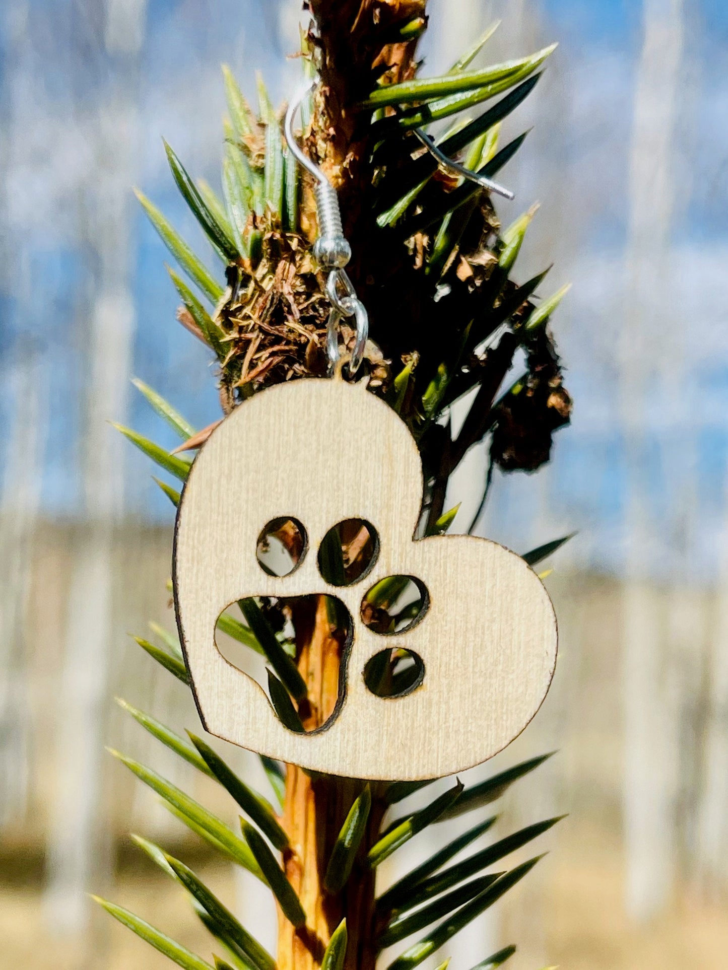 Solid heart dangle earring with a single paw print, hanging from the top side of the heart. They are laser cut, lightweight birchwood dangle earring that can be worn easily all day. Great gift for mom or any pet lover.