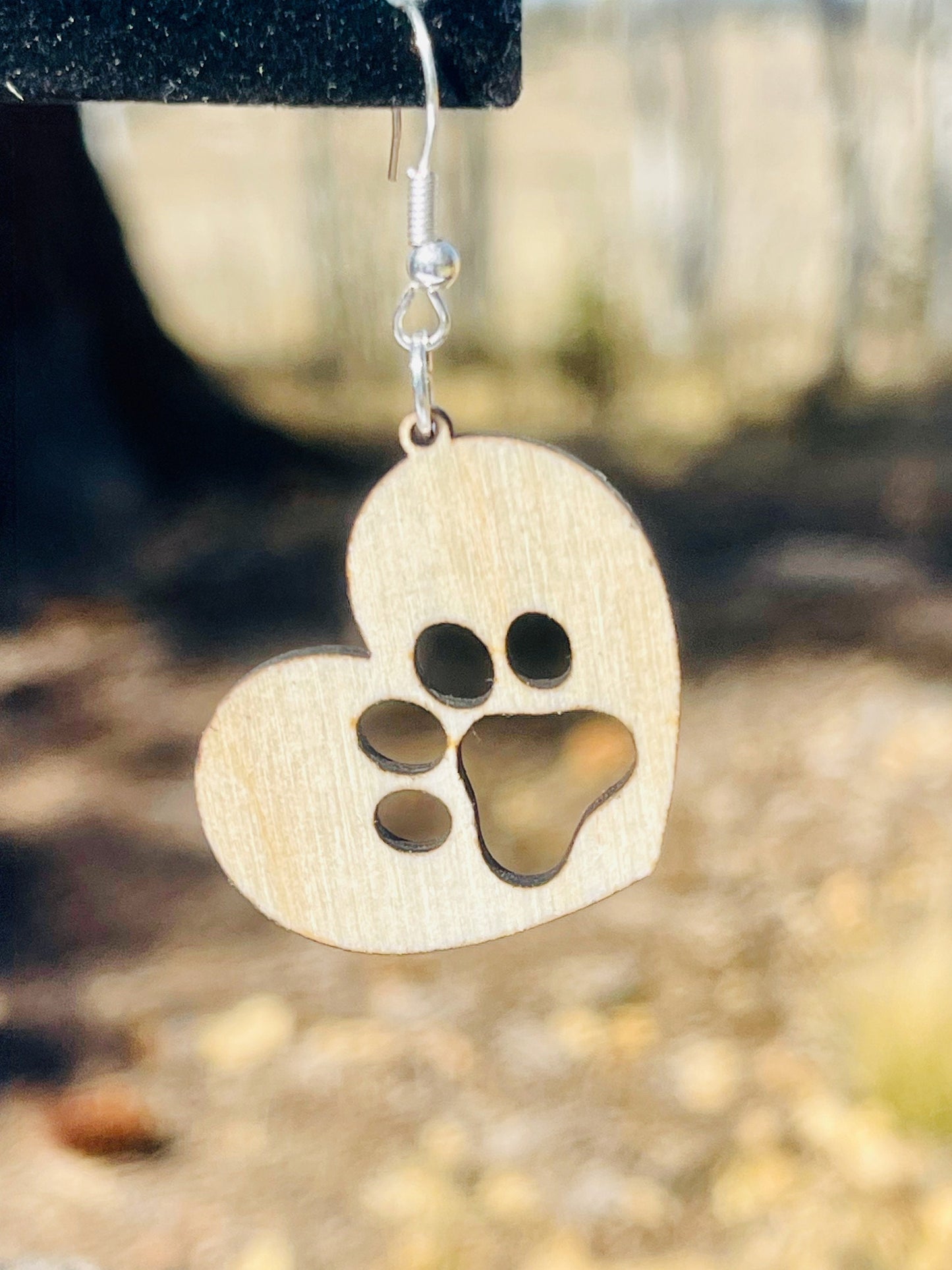 Solid heart dangle earring with a single paw print, hanging from the top side of the heart. They are laser cut, lightweight birchwood dangle earring that can be worn easily all day. Great gift for mom or any pet lover.