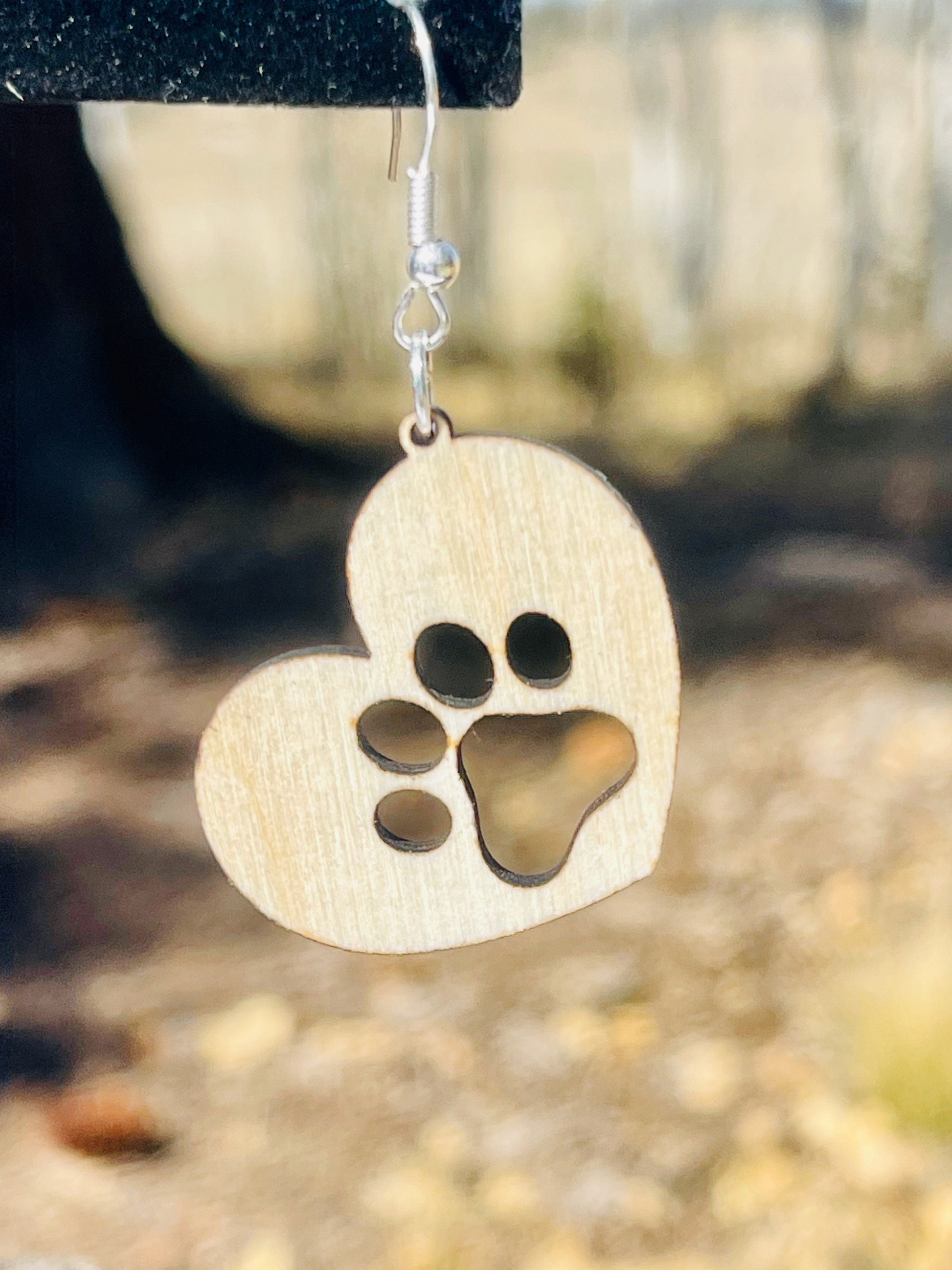Solid heart dangle earring with a single paw print, hanging from the top side of the heart. They are laser cut, lightweight birchwood dangle earring that can be worn easily all day. Great gift for mom or any pet lover.