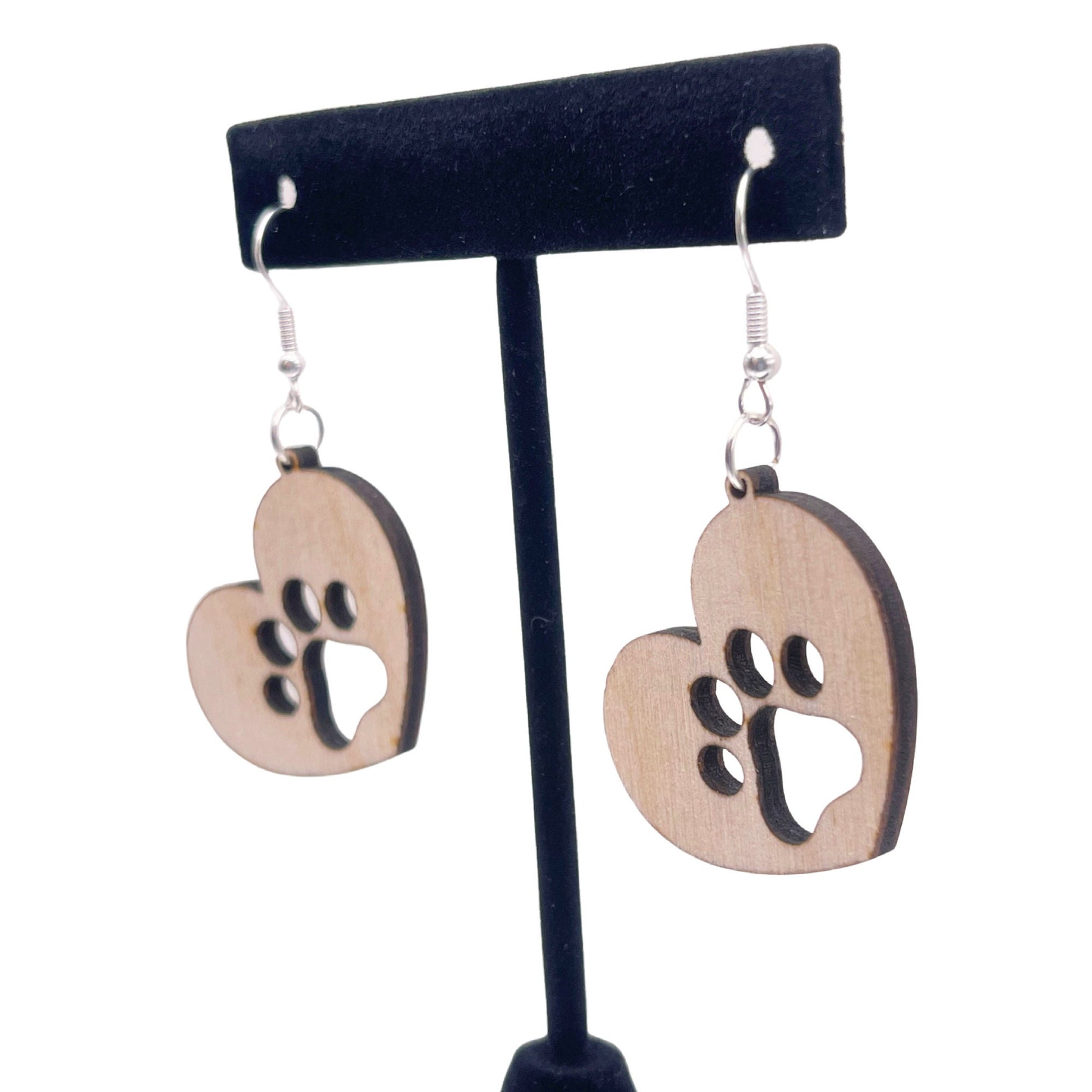 Solid heart dangle earring with a single paw print, hanging from the top side of the heart. They are laser cut, lightweight birchwood dangle earring that can be worn easily all day. Great gift for mom or any pet lover.