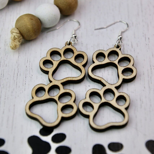 Double paw print dangle earrings to show the love for your favorite dog or cat. They are laser cut, lightweight birchwood that can be worn easily all day. 

Wood is a natural material. There will be color, texture and grain variations may occur.