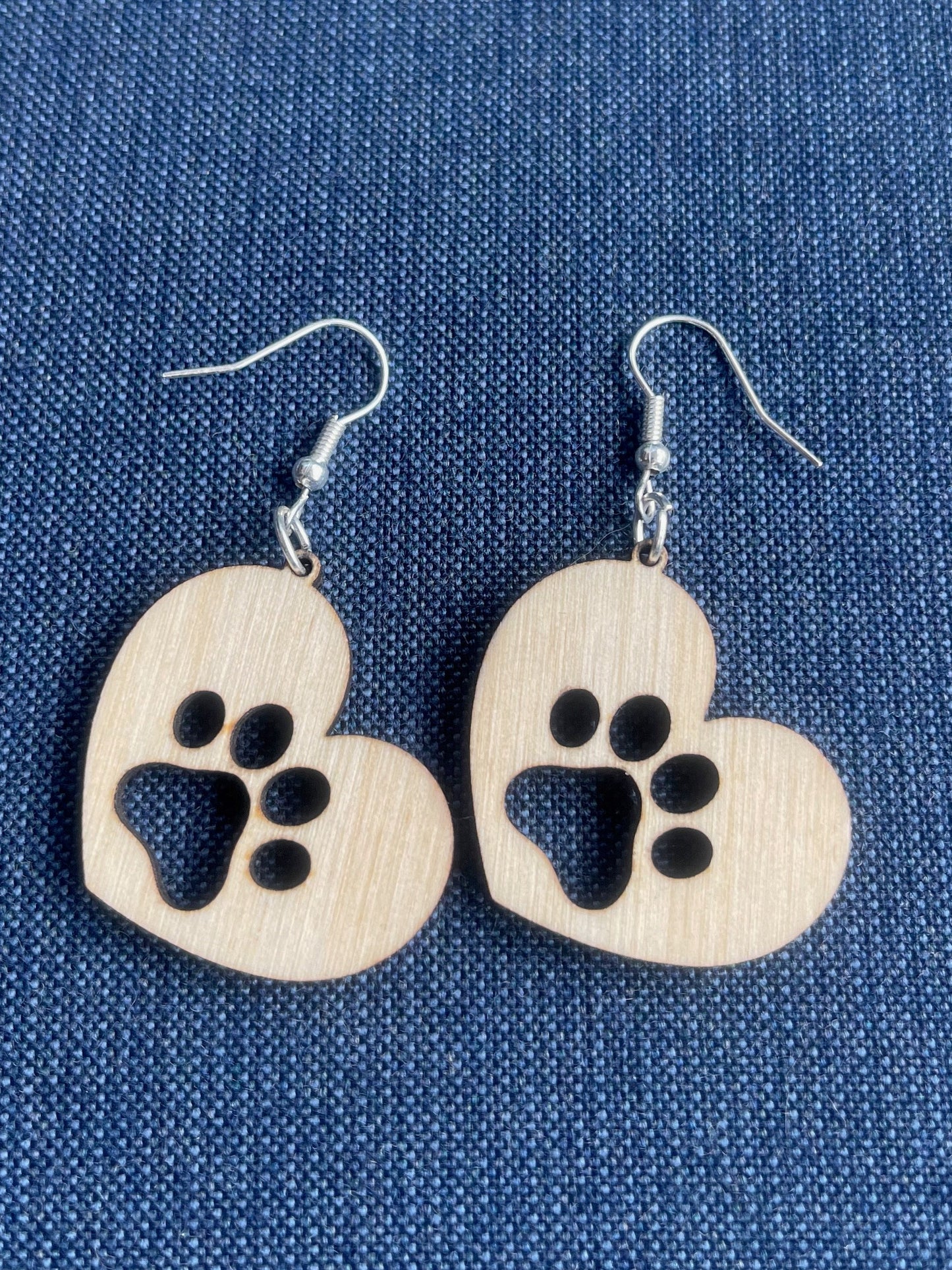 Solid heart dangle earring with a single paw print, hanging from the top side of the heart. They are laser cut, lightweight birchwood dangle earring that can be worn easily all day. Great gift for mom or any pet lover.